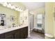 Bright bathroom featuring double sinks, vanity and walk-in shower with bench at 2941 Marlberry Ln, Clermont, FL 34714