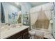 Bright bathroom featuring decorative tiles, a vanity with sink, and shower at 2941 Marlberry Ln, Clermont, FL 34714
