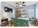 Cozy bedroom with ceiling fan, TV, and decorative accents at 2941 Marlberry Ln, Clermont, FL 34714