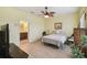 Cozy bedroom with an ensuite bathroom, ceiling fan and neutral color scheme at 2941 Marlberry Ln, Clermont, FL 34714