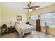 Inviting bedroom boasts natural light, a ceiling fan and ample storage at 2941 Marlberry Ln, Clermont, FL 34714