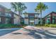 An inviting clubhouse entrance framed by palm trees and landscaped greenery at 2941 Marlberry Ln, Clermont, FL 34714