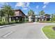 Community entrance featuring palm trees, flowers and modern building architecture at 2941 Marlberry Ln, Clermont, FL 34714