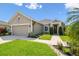 Charming single-story home featuring a well-manicured lawn and inviting front entrance at 2941 Marlberry Ln, Clermont, FL 34714