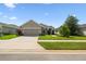 Well maintained single-story home showcasing an attached garage and a neat front lawn at 2941 Marlberry Ln, Clermont, FL 34714