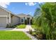 Lovely single-story home featuring a decorative front door and landscaped garden at 2941 Marlberry Ln, Clermont, FL 34714