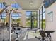 Bright gym with high ceilings, exercise equipment, and large windows overlooking landscaped grounds at 2941 Marlberry Ln, Clermont, FL 34714