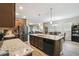 Open kitchen and dining area featuring granite counters, stainless appliances, and wood floors at 2941 Marlberry Ln, Clermont, FL 34714