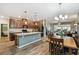 Open kitchen and dining area featuring granite counters, stainless appliances, and wood floors at 2941 Marlberry Ln, Clermont, FL 34714