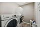 Efficient laundry room with washer, dryer, and storage shelving for organization at 2941 Marlberry Ln, Clermont, FL 34714