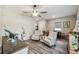 Bright and airy living room includes neutral walls, modern flooring and a ceiling fan at 2941 Marlberry Ln, Clermont, FL 34714