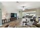 Spacious living room with hardwood floors, ceiling fan, and view to screened patio at 2941 Marlberry Ln, Clermont, FL 34714