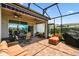 Spacious screened patio features ceiling fans, comfortable lounge furniture, and views of the backyard at 2941 Marlberry Ln, Clermont, FL 34714