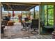 A brick-paved patio offers a serene view of the lake and includes a dining area and cozy seating arrangement at 2941 Marlberry Ln, Clermont, FL 34714