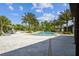 Community pool area featuring a large pool deck with ample seating, palm trees, and a well-maintained pool area for residents at 2941 Marlberry Ln, Clermont, FL 34714