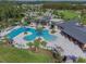 The community's recreational pool features various amenities and palm trees providing the perfect hangout spot at 2941 Marlberry Ln, Clermont, FL 34714