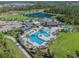 Aerial view showcases the community pool, clubhouse and playground, offering a variety of activities at 2941 Marlberry Ln, Clermont, FL 34714