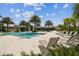 Inviting community pool area with palm trees, ample seating, and a well-maintained pool deck, perfect for relaxation at 2941 Marlberry Ln, Clermont, FL 34714