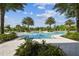 Beautiful community pool area with lush landscaping, palm trees, and ample seating for relaxation and enjoyment on sunny days at 2941 Marlberry Ln, Clermont, FL 34714