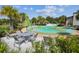 Community splash pad featuring lounge seating, tables, and vibrant green play areas for children to enjoy in the Florida sunshine at 2941 Marlberry Ln, Clermont, FL 34714