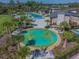 This overhead view shows the splash pad area surrounded by palm trees, and seating options at 2941 Marlberry Ln, Clermont, FL 34714