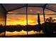 Stunning sunset view reflecting over the water, seen from the screened-in lanai at 2941 Marlberry Ln, Clermont, FL 34714