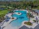 Aerial view of a resort-style swimming pool with palm trees and ample seating at 2941 Marlberry Ln, Clermont, FL 34714