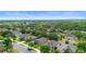 Aerial view of a residential neighborhood featuring well-maintained homes, green lawns, and mature trees at 30245 Cheval St, Mount Dora, FL 32757