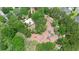 An aerial view showcases a playground with colorful equipment, surrounded by trees in a verdant neighborhood park at 30245 Cheval St, Mount Dora, FL 32757