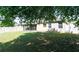 This fenced-in backyard features a grassy lawn, mature landscaping, and a screened-in porch at 30245 Cheval St, Mount Dora, FL 32757