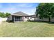 Expansive backyard with lush green grass, privacy fence, and screened in patio area at 30245 Cheval St, Mount Dora, FL 32757