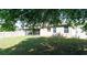 This fenced-in backyard features a grassy lawn, mature landscaping, and a screened-in porch at 30245 Cheval St, Mount Dora, FL 32757
