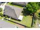 Aerial view of backyard with privacy fence, mature trees, and covered patio at 30245 Cheval St, Mount Dora, FL 32757