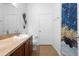 Bathroom features a single sink vanity with dark wood cabinets, stylish shower curtain and tile flooring for a modern look at 30245 Cheval St, Mount Dora, FL 32757