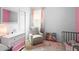 Bright bedroom with plush pink carpet, pastel colored dresser and a window with natural light at 30245 Cheval St, Mount Dora, FL 32757