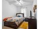 Comfortable bedroom with a patterned quilt, dark wood furniture, ceiling fan and a TV for a relaxing ambiance at 30245 Cheval St, Mount Dora, FL 32757