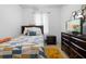 Cozy bedroom featuring a patterned quilt, dark wood furniture, and a TV, creating a comfortable and relaxing retreat at 30245 Cheval St, Mount Dora, FL 32757