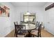 Dining area with wood table, six chairs and sliding glass doors that open to the patio at 30245 Cheval St, Mount Dora, FL 32757