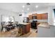 Bright kitchen with island and bar stool seating, stainless steel appliances, and a dining area at 30245 Cheval St, Mount Dora, FL 32757