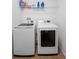 A well-lit laundry room features a full-sized washer and dryer set and overhead wire shelving at 30245 Cheval St, Mount Dora, FL 32757