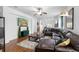 Cozy living room with large sectional, wood floors, and an open layout connecting to the kitchen and dining areas at 30245 Cheval St, Mount Dora, FL 32757