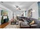 Inviting living room with a large sectional, wood floors, a ceiling fan, and an open layout at 30245 Cheval St, Mount Dora, FL 32757
