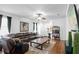 Bright living room with plush sectional, stylish decor, ceiling fan, and media display at 30245 Cheval St, Mount Dora, FL 32757
