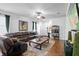Cozy living room with a plush sectional, wood floors, ceiling fan, and open layout to the kitchen at 30245 Cheval St, Mount Dora, FL 32757
