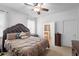 Main bedroom featuring a luxurious bed, dark wood furniture, and a glimpse into the en-suite bathroom for a relaxing retreat at 30245 Cheval St, Mount Dora, FL 32757