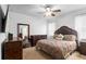 Main bedroom featuring a luxurious bed, dark wood furniture, and a TV for a relaxing and inviting atmosphere at 30245 Cheval St, Mount Dora, FL 32757