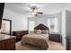 Main bedroom featuring a luxurious bed, dark wood furniture, and natural light, creating a relaxing and inviting atmosphere at 30245 Cheval St, Mount Dora, FL 32757