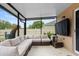 Covered and screened outdoor patio featuring a modular sectional sofa and mounted TV at 30245 Cheval St, Mount Dora, FL 32757