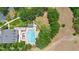 Aerial view of a large pool and sundeck with lounge chairs surrounded by lush landscaping at 30245 Cheval St, Mount Dora, FL 32757
