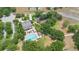 Aerial view of community pool with sundeck and clubhouse surrounded by lush landscaping at 30245 Cheval St, Mount Dora, FL 32757